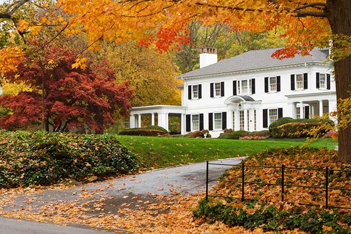 Big house surrounded by trees in fall