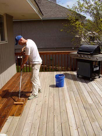 Man painting the wooden floor